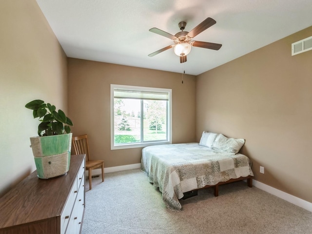 carpeted bedroom featuring baseboards and ceiling fan