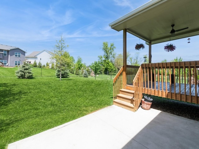 view of yard with ceiling fan, a patio area, and a deck