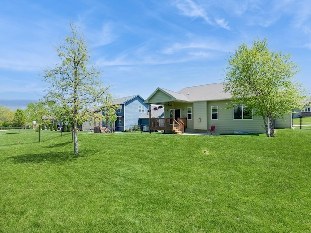 back of property featuring a yard and a patio