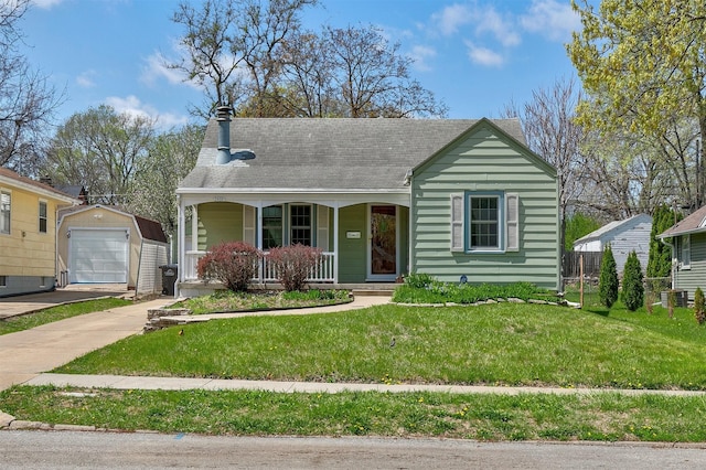 2400 39th St, Des Moines, IA 50310 - view of front of home with covered porch, an outdoor structure, driveway, a front yard, and a chimney