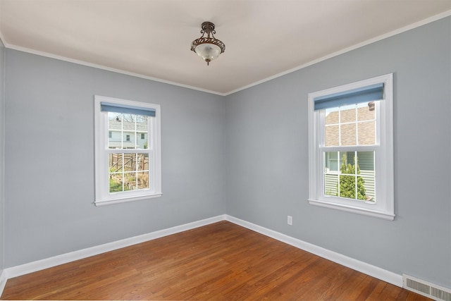 2400 39th St, Des Moines, IA 50310 - spare room featuring baseboards, wood finished floors, and ornamental molding