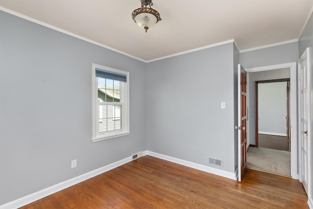 2400 39th St, Des Moines, IA 50310 - unfurnished room featuring wood finished floors, baseboards, and crown molding
