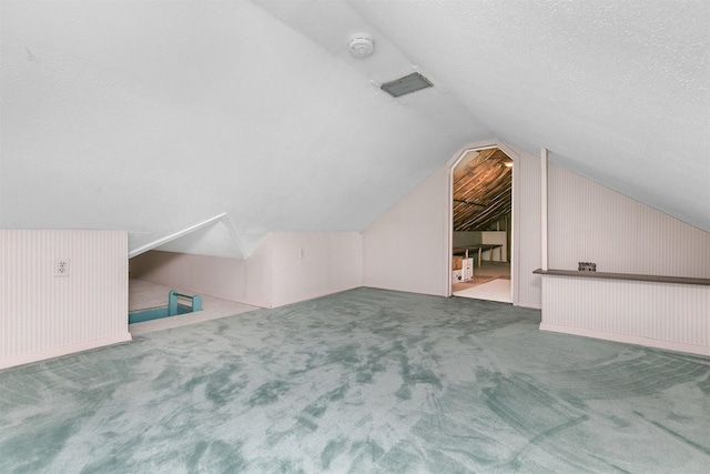 2400 39th St, Des Moines, IA 50310 - bonus room featuring vaulted ceiling, carpet floors, and a textured ceiling