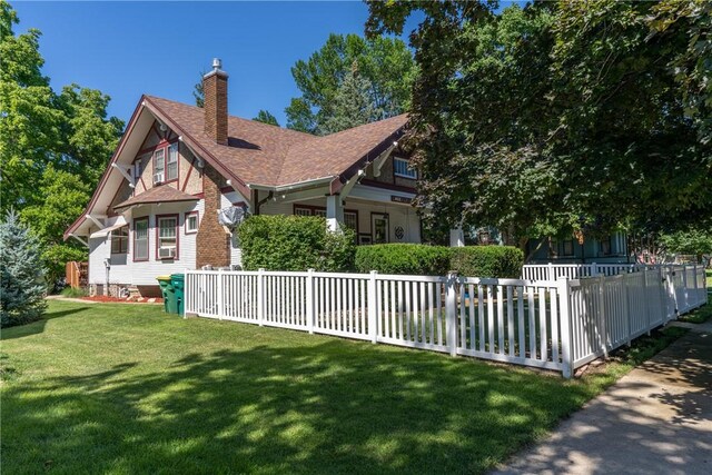view of home's exterior with a chimney and a shingled roof