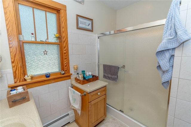 full bathroom featuring a baseboard heating unit, tile walls, a shower stall, and vanity
