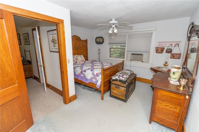 carpeted bedroom with a textured ceiling, ceiling fan, baseboards, and cooling unit