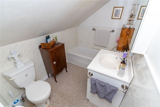 bathroom with toilet, vanity, a bath, and vaulted ceiling