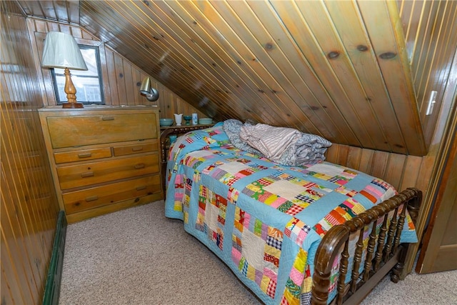 bedroom featuring vaulted ceiling, carpet, and wood walls