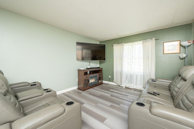 102 Wall Ave, Des Moines, IA 50315 - living room featuring light wood-style flooring, baseboards, and lofted ceiling