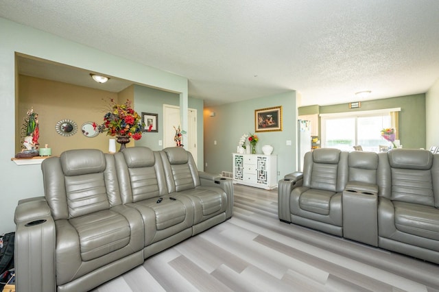 102 Wall Ave, Des Moines, IA 50315 - living area featuring a textured ceiling and wood finished floors