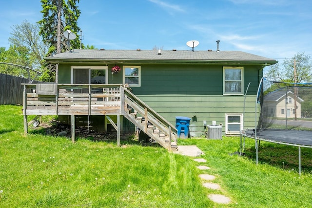 102 Wall Ave, Des Moines, IA 50315 - rear view of house featuring a trampoline, a wooden deck, and stairs