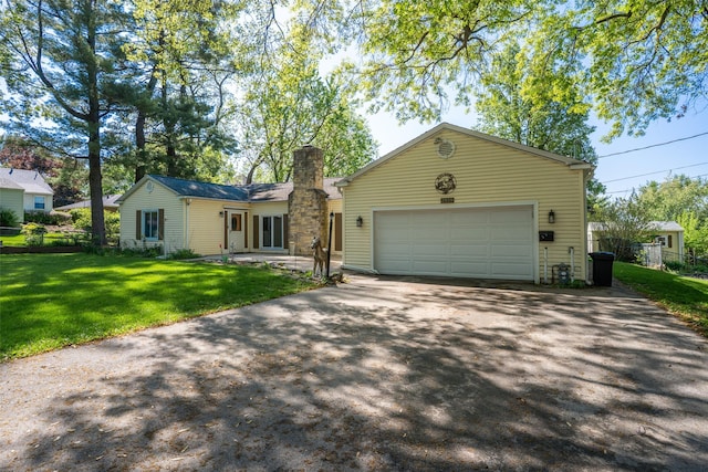ranch-style home featuring asphalt driveway, a chimney, and an attached garage