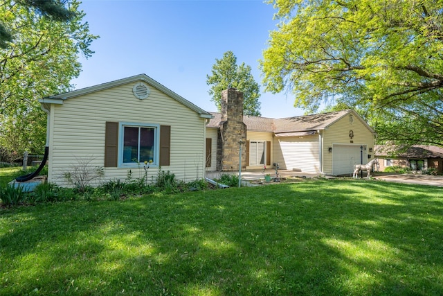single story home with a garage, a chimney, and a front yard