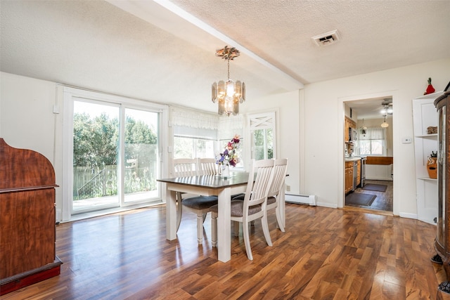 dining area with wood finished floors, a baseboard heating unit, a chandelier, and a textured ceiling