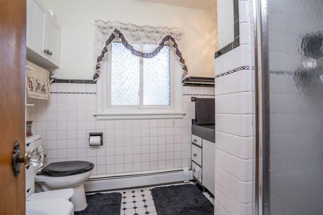 full bath with a baseboard radiator, tile walls, and toilet