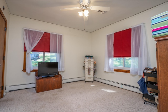 carpeted office space featuring baseboard heating and ceiling fan