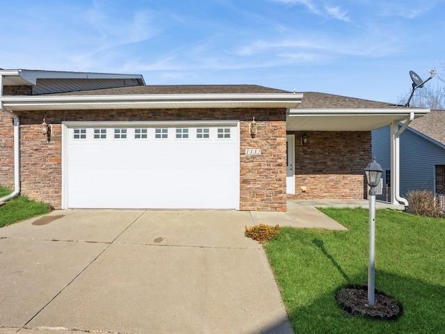 1132 S Goodrich St, Colfax, IA 50054 - view of front of home featuring an attached garage, driveway, a front lawn, and stone siding