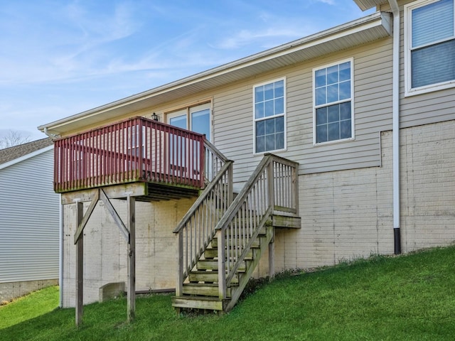 1132 S Goodrich St, Colfax, IA 50054 - rear view of house with a deck, brick siding, stairway, and a lawn
