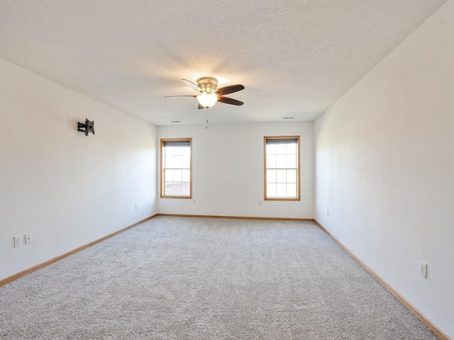 1132 S Goodrich St, Colfax, IA 50054 - empty room with light carpet, ceiling fan, baseboards, and a textured ceiling
