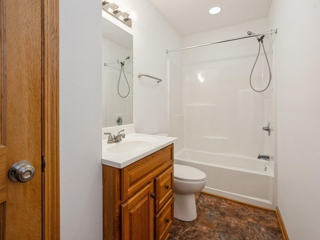 1132 S Goodrich St, Colfax, IA 50054 - bathroom featuring vanity, bathing tub / shower combination, toilet, stone finish flooring, and baseboards