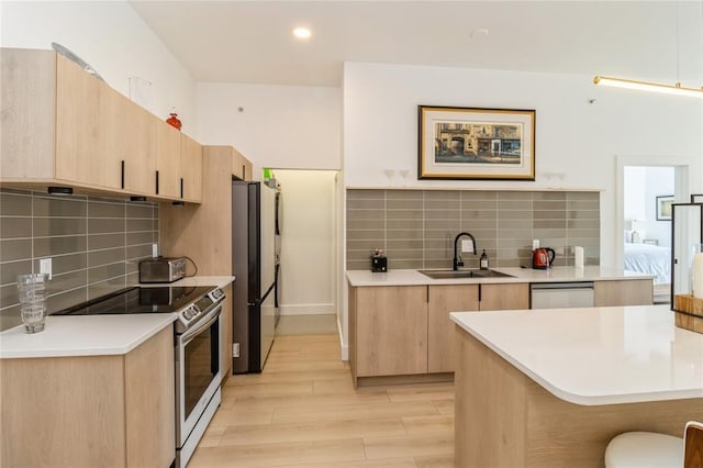 400 E Locust St Unit 203, Des Moines, IA 50309 - kitchen with a sink, light brown cabinets, appliances with stainless steel finishes, light wood-style flooring, and recessed lighting