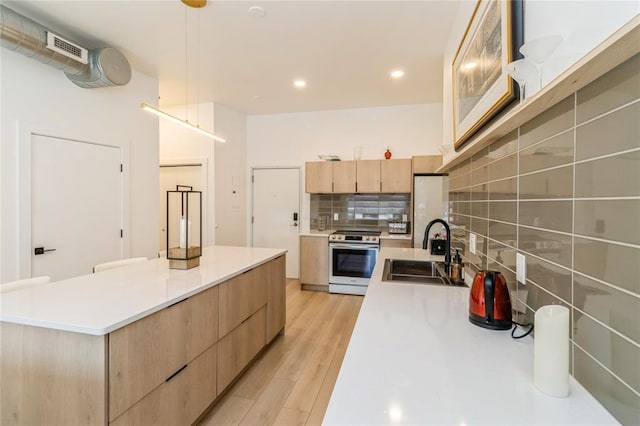 400 E Locust St Unit 203, Des Moines, IA 50309 - kitchen with electric stove, a sink, light brown cabinets, modern cabinets, and backsplash