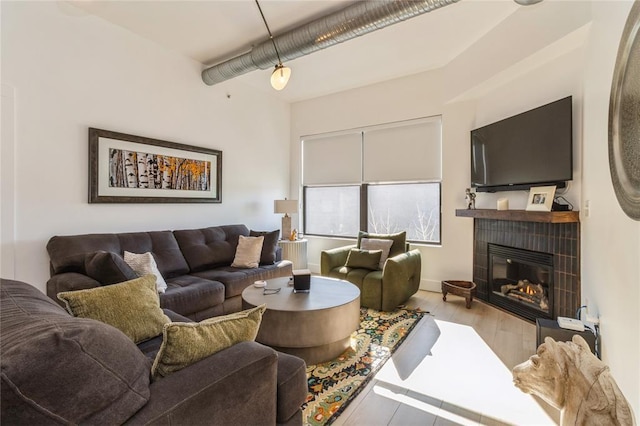 400 E Locust St Unit 203, Des Moines, IA 50309 - living area featuring a tile fireplace and wood finished floors