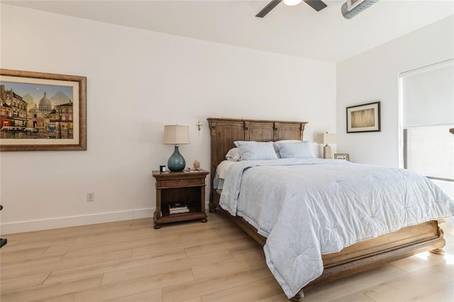 400 E Locust St Unit 203, Des Moines, IA 50309 - bedroom with light wood-style floors, baseboards, and a ceiling fan