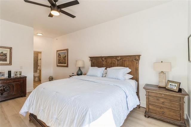 400 E Locust St Unit 203, Des Moines, IA 50309 - bedroom with light wood-style flooring, ensuite bathroom, ceiling fan, and baseboards