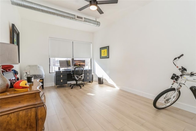 400 E Locust St Unit 203, Des Moines, IA 50309 - home office featuring ceiling fan, light wood finished floors, and baseboards