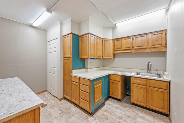 3936 Hubbell Ave, Des Moines, IA 50317 - kitchen with a sink, light countertops, ornamental molding, and brown cabinetry