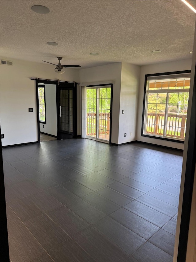 950 67th St Unit 321, West Des Moines, IA 50266 - spare room with ceiling fan, a textured ceiling, and baseboards