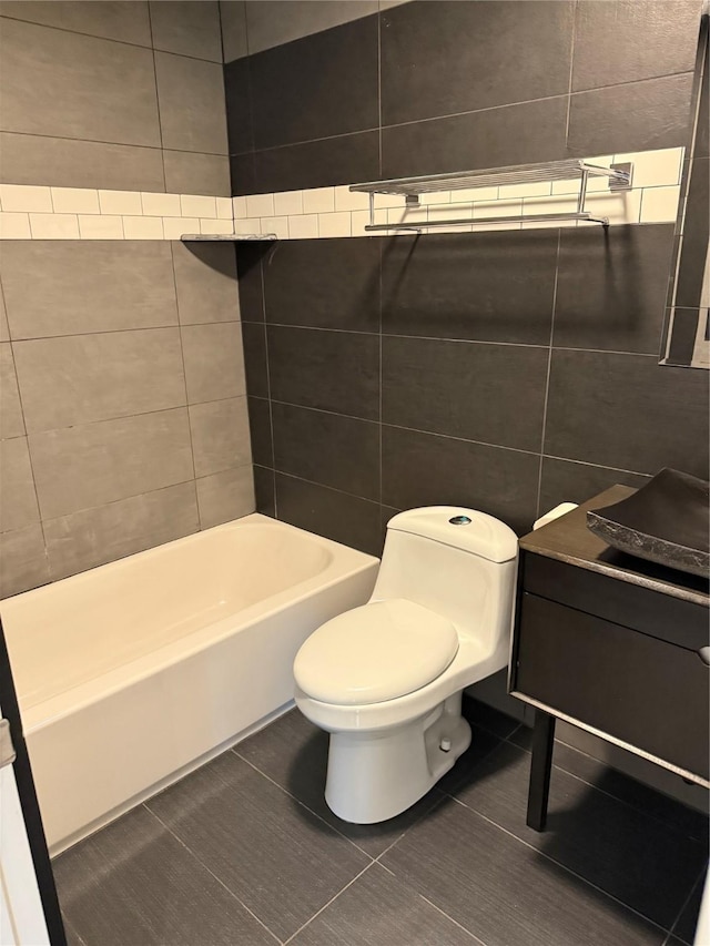 950 67th St Unit 321, West Des Moines, IA 50266 - full bathroom featuring toilet, tile patterned flooring, and tile walls
