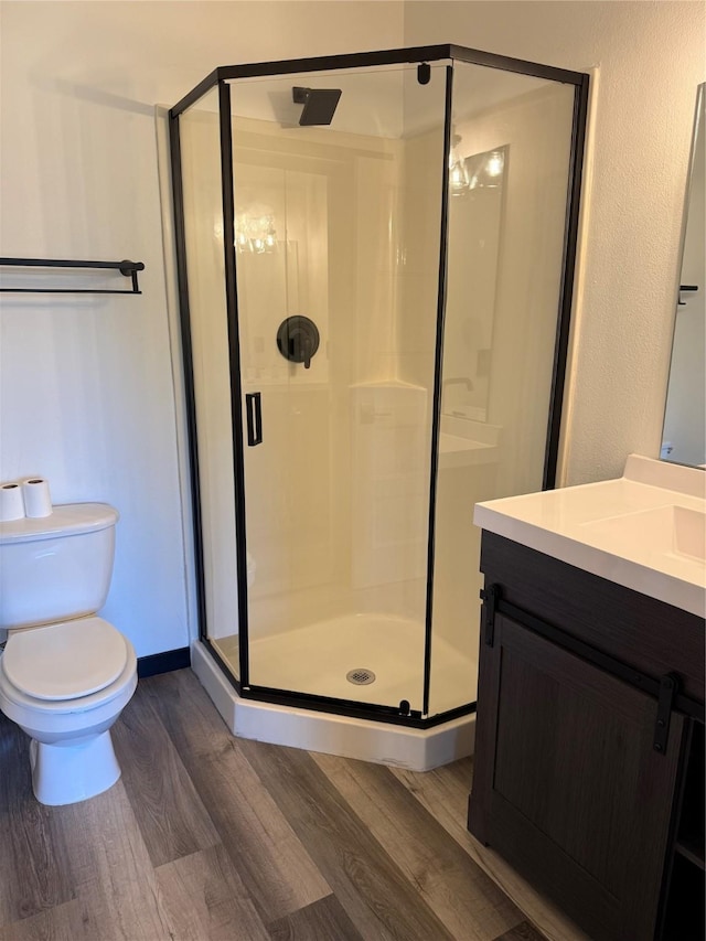 950 67th St Unit 321, West Des Moines, IA 50266 - bathroom with wood finished floors, vanity, a stall shower, and toilet