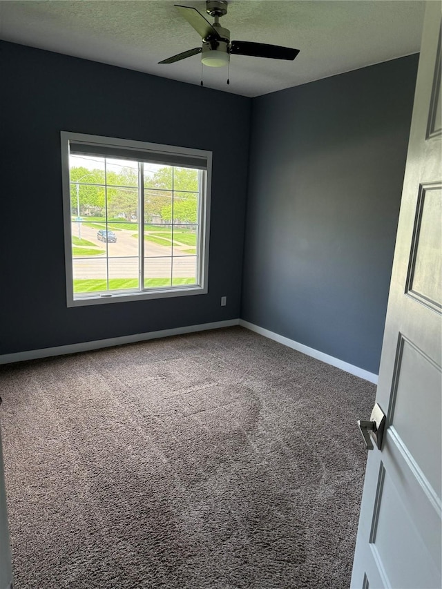 950 67th St Unit 321, West Des Moines, IA 50266 - carpeted spare room featuring a ceiling fan, baseboards, and a textured ceiling