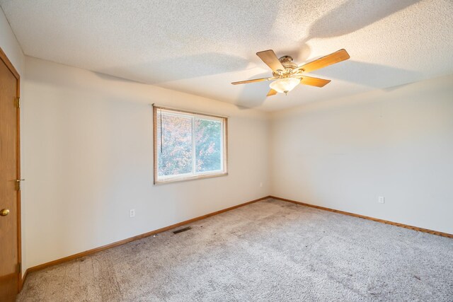 1634 Prairie Cir, Altoona, IA 50009 - empty room with light carpet, a ceiling fan, baseboards, and a textured ceiling