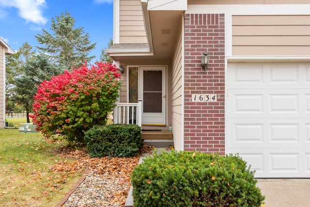 1634 Prairie Cir, Altoona, IA 50009 - property entrance with brick siding and a garage