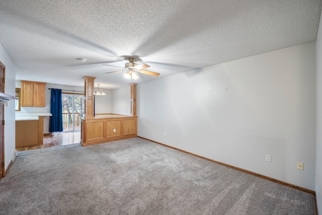 1634 Prairie Cir, Altoona, IA 50009 - unfurnished living room with a ceiling fan, light colored carpet, a textured ceiling, baseboards, and a chandelier