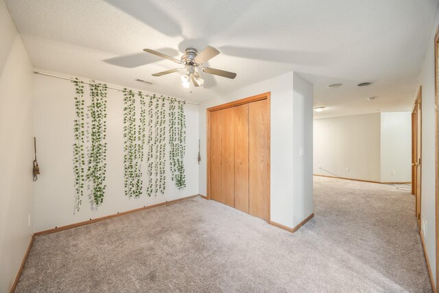 1634 Prairie Cir, Altoona, IA 50009 - unfurnished bedroom with carpet floors, baseboards, ceiling fan, and a closet
