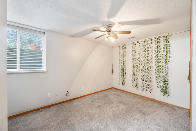 1634 Prairie Cir, Altoona, IA 50009 - spare room with a ceiling fan, carpet floors, a textured ceiling, and baseboards
