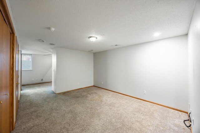 1634 Prairie Cir, Altoona, IA 50009 - carpeted empty room with baseboards, a textured ceiling, and a smoke detector