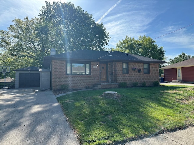 view of front of house featuring brick siding, concrete driveway, an outdoor structure, a front lawn, and a chimney