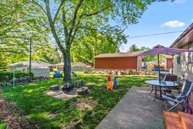 3101 Roblang Ct, Des Moines, IA 50317 - view of yard featuring an outdoor fire pit and a patio area