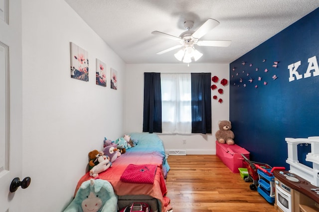3101 Roblang Ct, Des Moines, IA 50317 - bedroom with wood finished floors, a textured ceiling, and ceiling fan