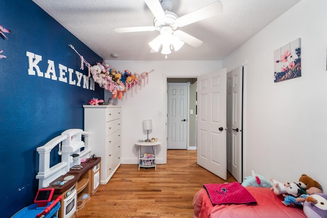 3101 Roblang Ct, Des Moines, IA 50317 - bedroom featuring wood finished floors, ceiling fan, and a textured ceiling