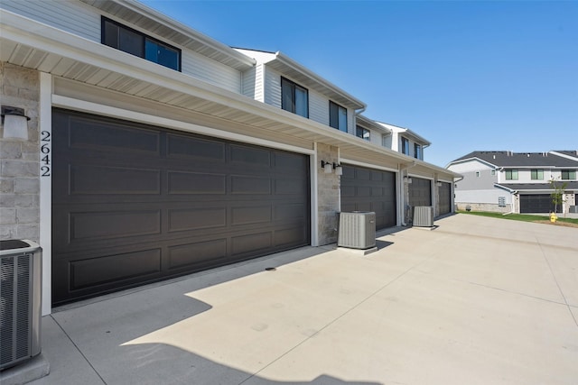 2642 SE Osier Ave, West Des Moines, IA 50265 - garage featuring concrete driveway and a residential view