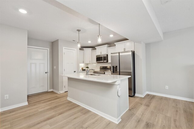 2642 SE Osier Ave, West Des Moines, IA 50265 - kitchen featuring appliances with stainless steel finishes, recessed lighting, light wood-style floors, white cabinetry, and light countertops