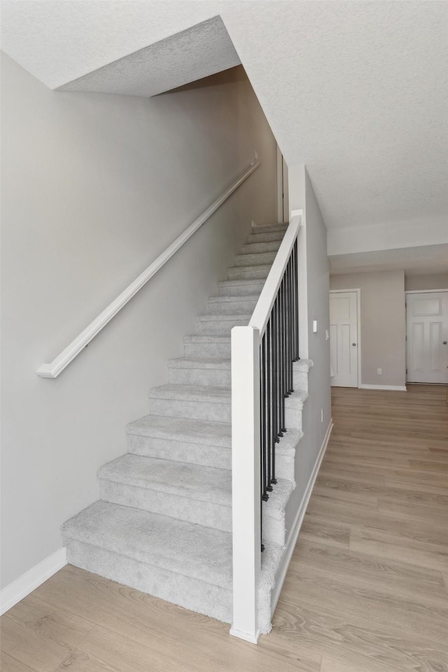 2642 SE Osier Ave, West Des Moines, IA 50265 - stairway featuring baseboards and wood finished floors