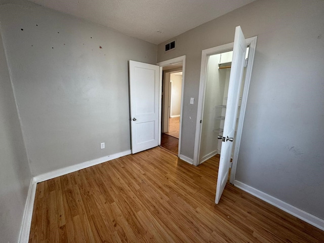 619 Palmer Pl, Des Moines, IA 50315 - unfurnished bedroom featuring light wood-type flooring and baseboards