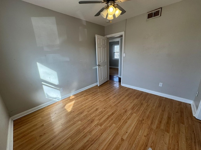 619 Palmer Pl, Des Moines, IA 50315 - empty room with a ceiling fan, light wood-type flooring, and baseboards